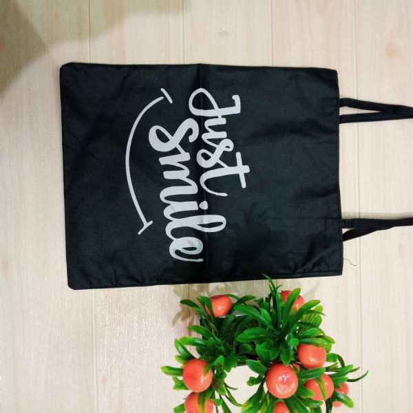 ini adalah Totebag Just, size: 40cm x 35cm, material: canvas, color: black, brand: Totebagcepu, age_group: all ages, gender: female